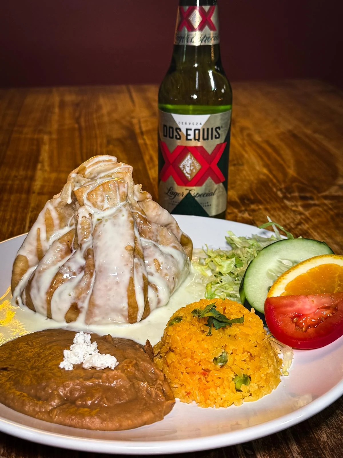 A cream-sauce entrée plate with rice, refried beans and fresh garnishes at Jalapeños in Lubbock