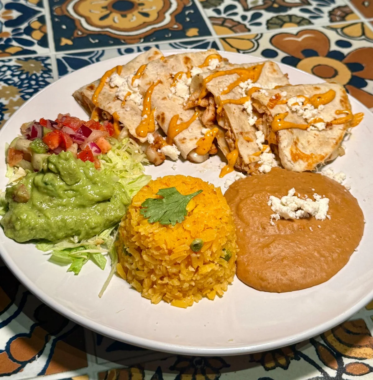 Jalapeños Quesadillas with chipotle aioli, rice, refried beans, guacamole and salad